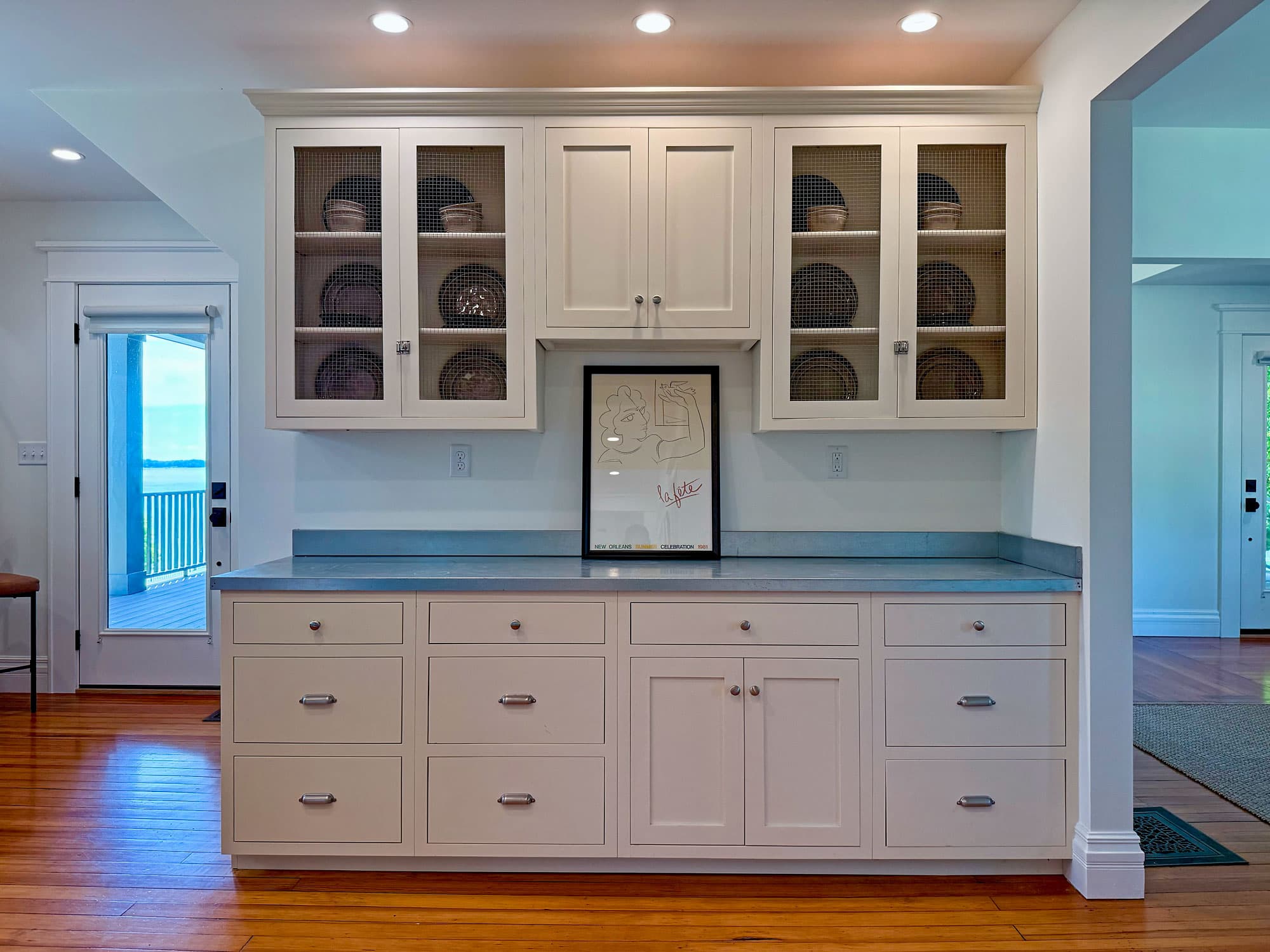 Custom butler's pantry with wire-mesh cabinet doors and soapstone countertop