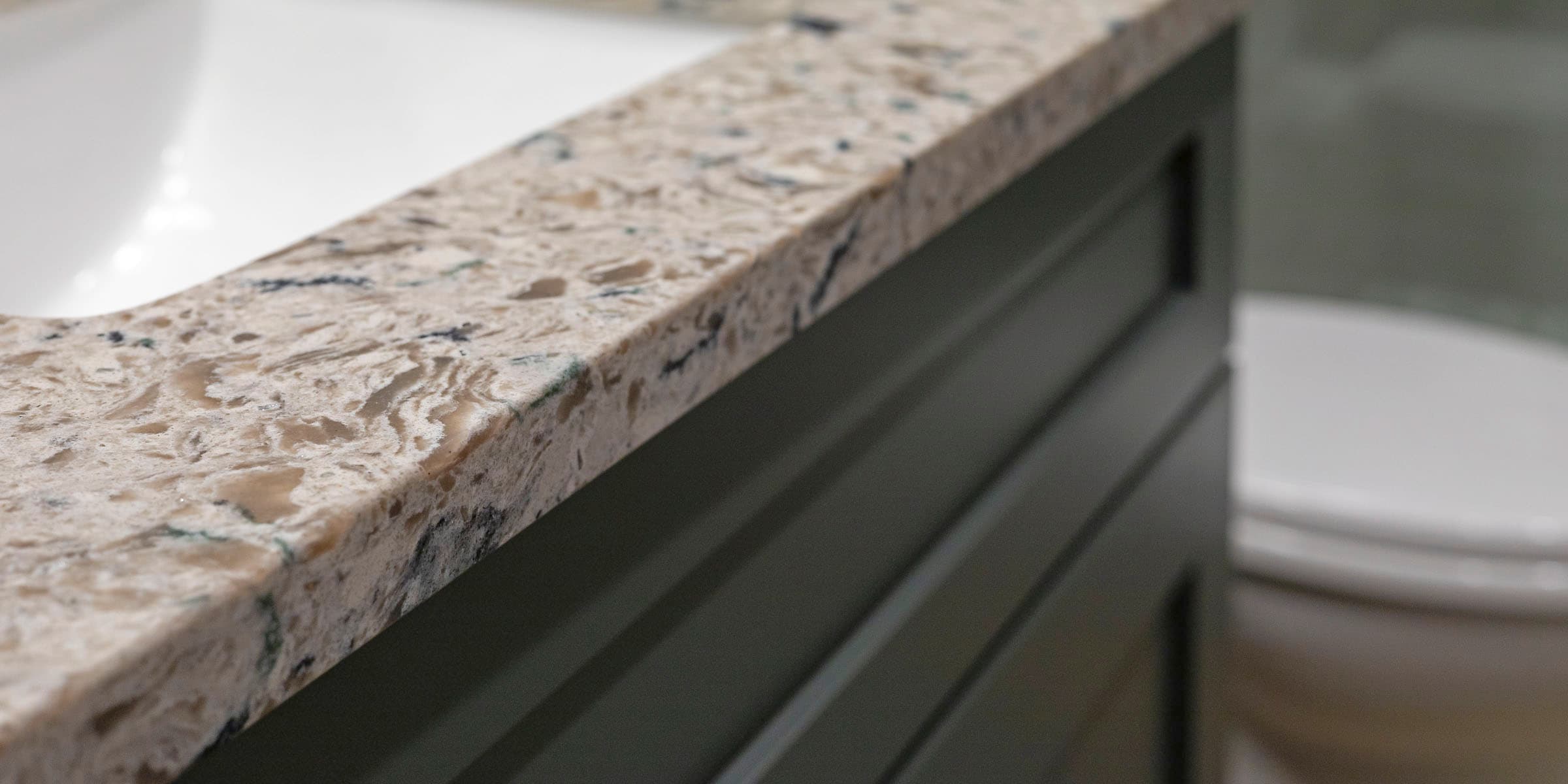 Premium quartz countertop edge profile on dark cabinet